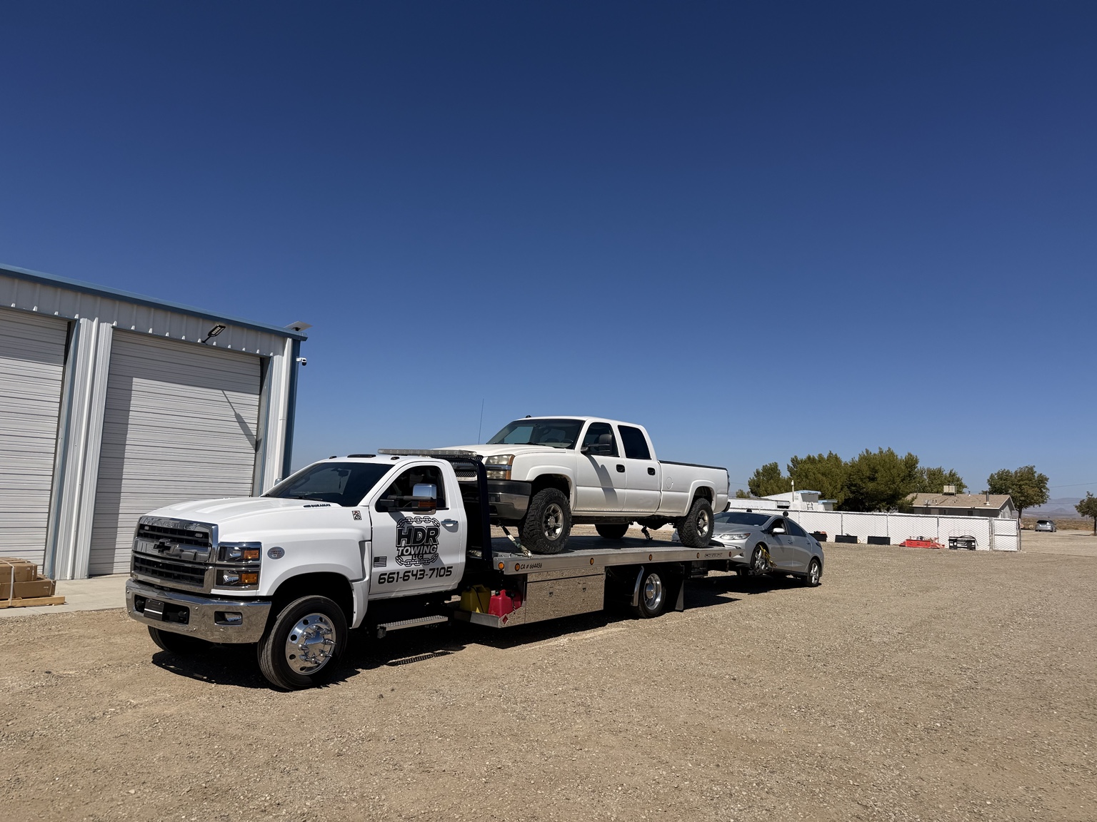 HDR tow truck carrying pickup